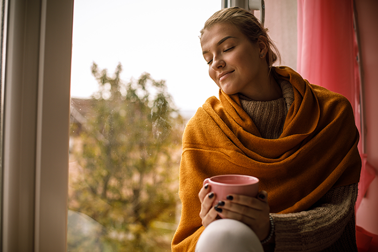 woman smiling in fall with coffee